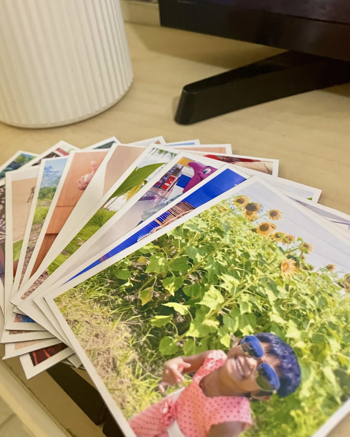A fanned stack of flexible photo magnets with white borders