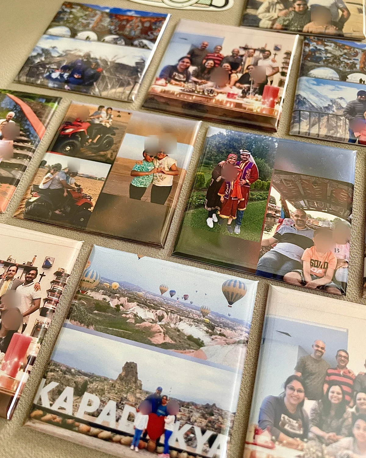A table of classic 3D magnets with a family's travel photos, from a hot air balloon trip to a desert ride